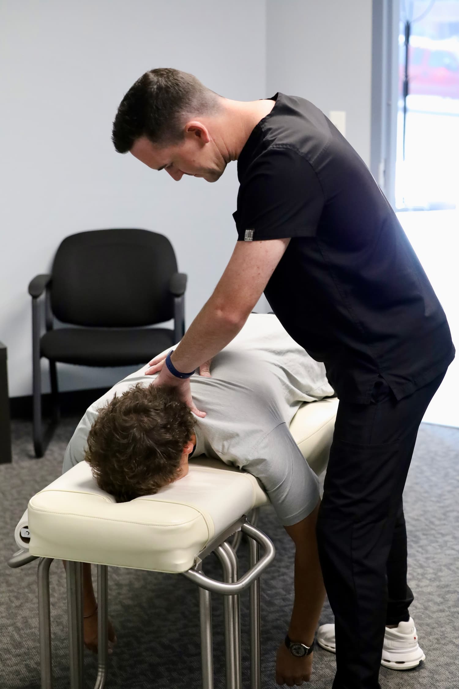 Chiropractor performing an adjustment on a patient at Frost Chiropractic