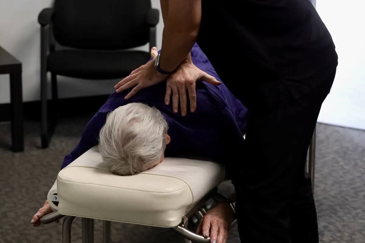 Patient receiving a back adjustment at Frost Chiropractic in Tulsa
