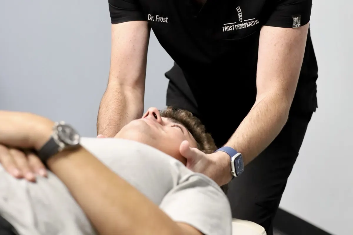 Dr. Frost performing a gentle neck adjustment