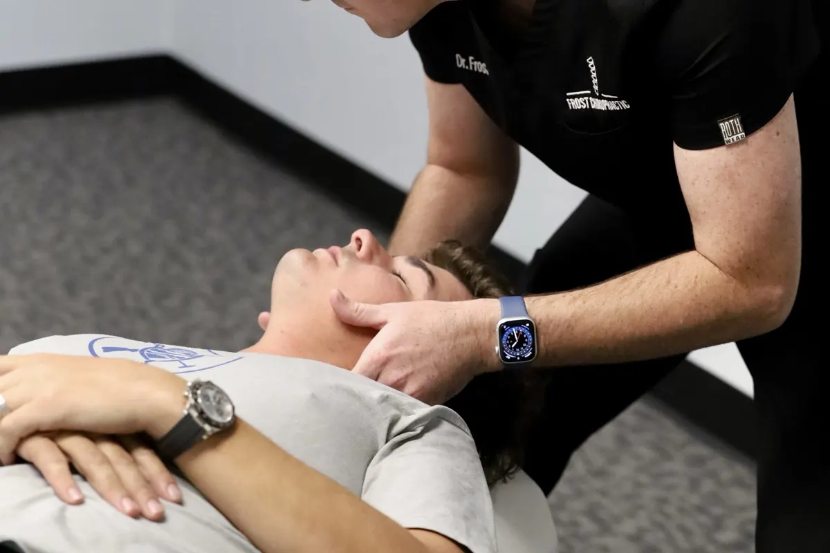 Patient receiving a gentle neck adjustment at Frost Chiropractic