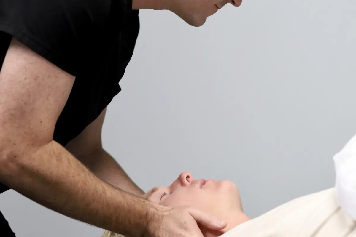 Patient receiving a gentle upper-neck adjustment at Frost Chiropractic